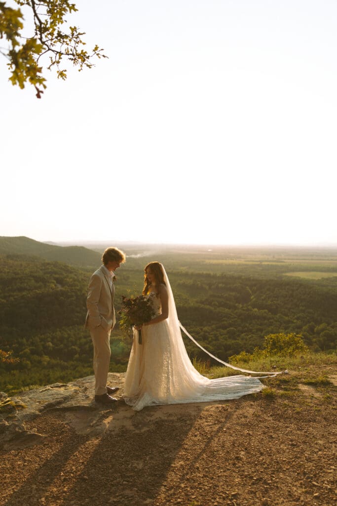 Authentic documentary-style elopement photography showing emotional first look in St. Petit Jean State Park, Arkansas